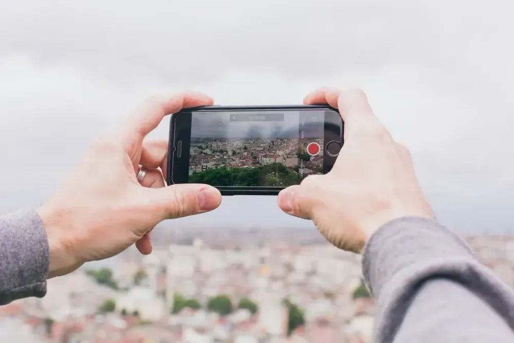 smartphone taking a photo of cityscape